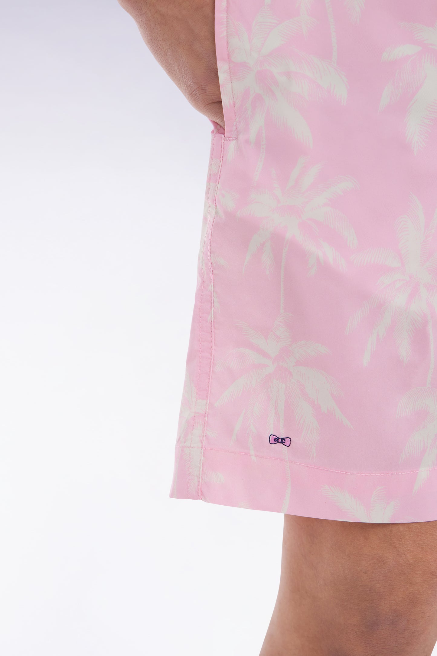 Pink swimsuit with palm tree print