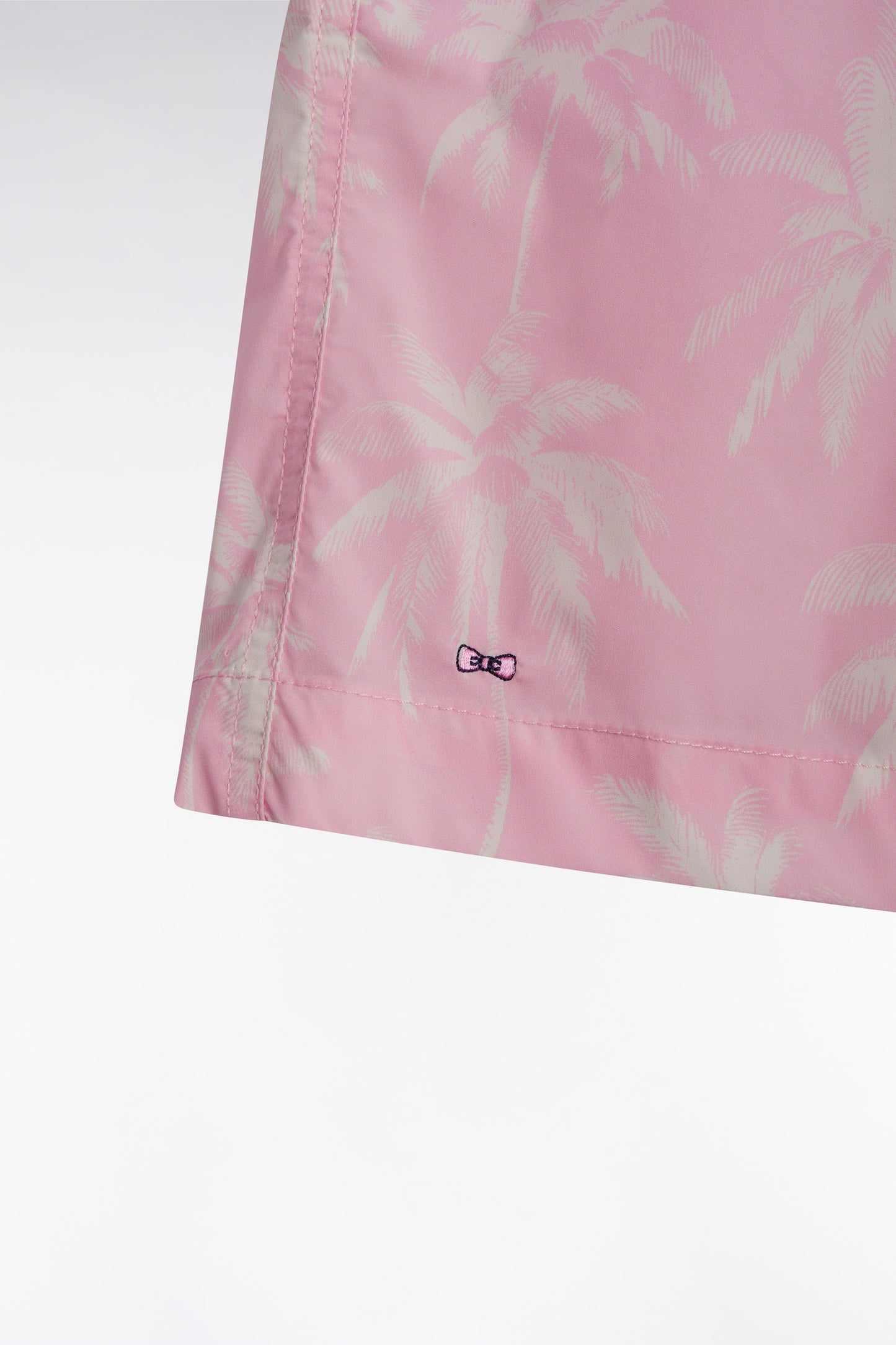 Pink swimsuit with palm tree print