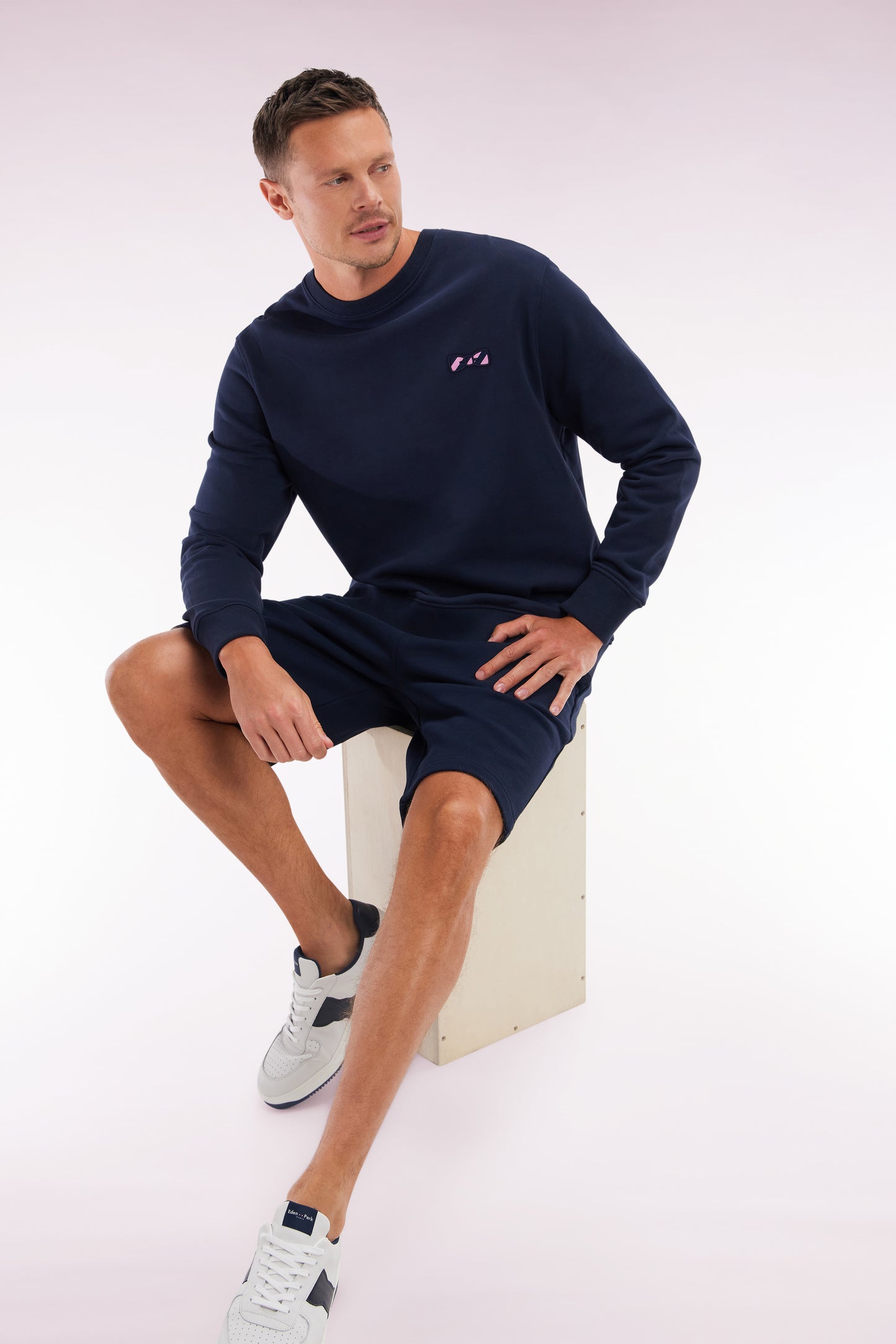 Relaxed-fit navy cotton fleece shorts with a striped bow tie embroidery