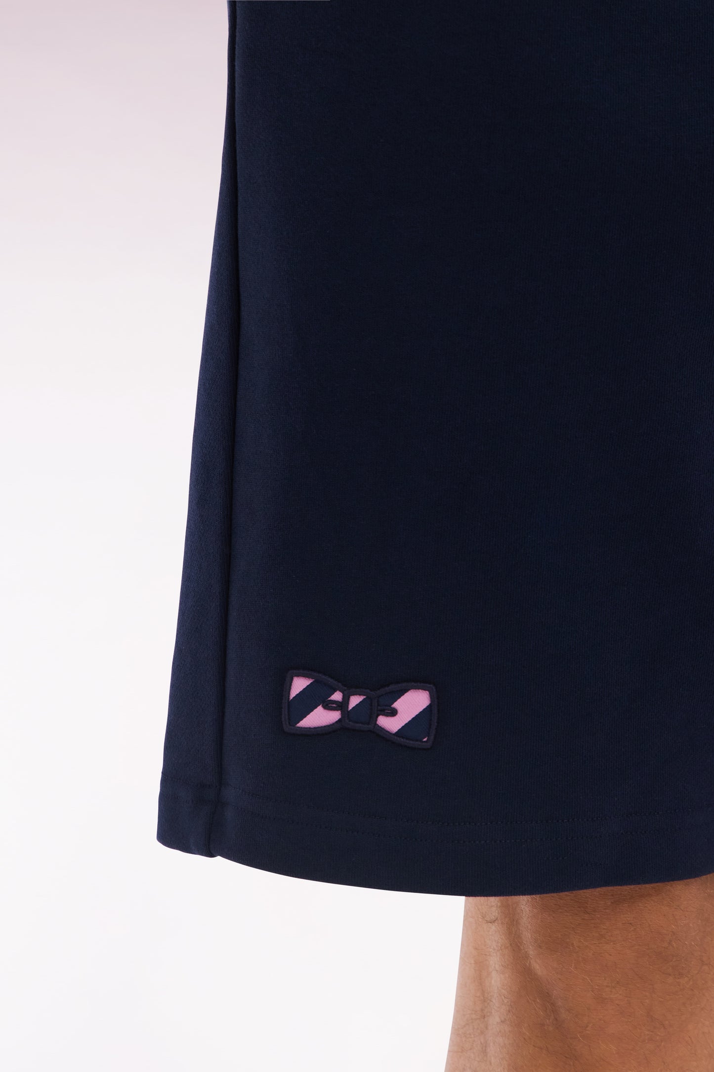 Relaxed-fit navy cotton fleece shorts with a striped bow tie embroidery