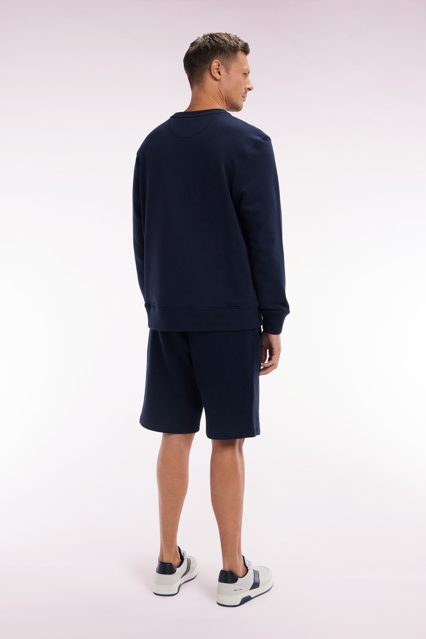 Relaxed-fit navy cotton fleece shorts with a striped bow tie embroidery