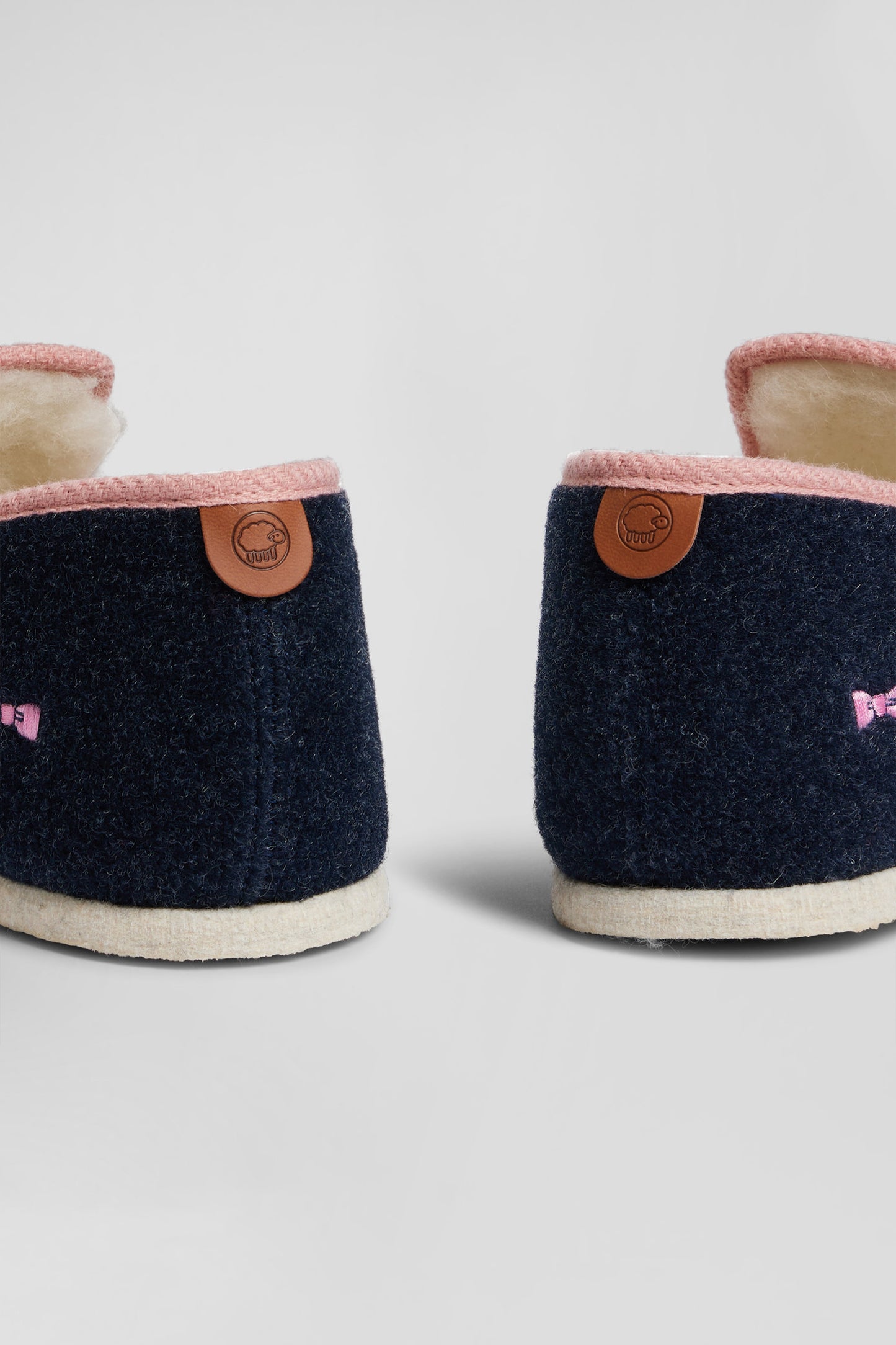 Navy blue shearling slippers with pink trim