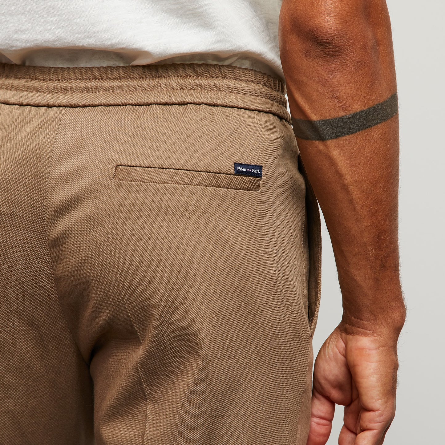 Beige trousers with loose pleats
