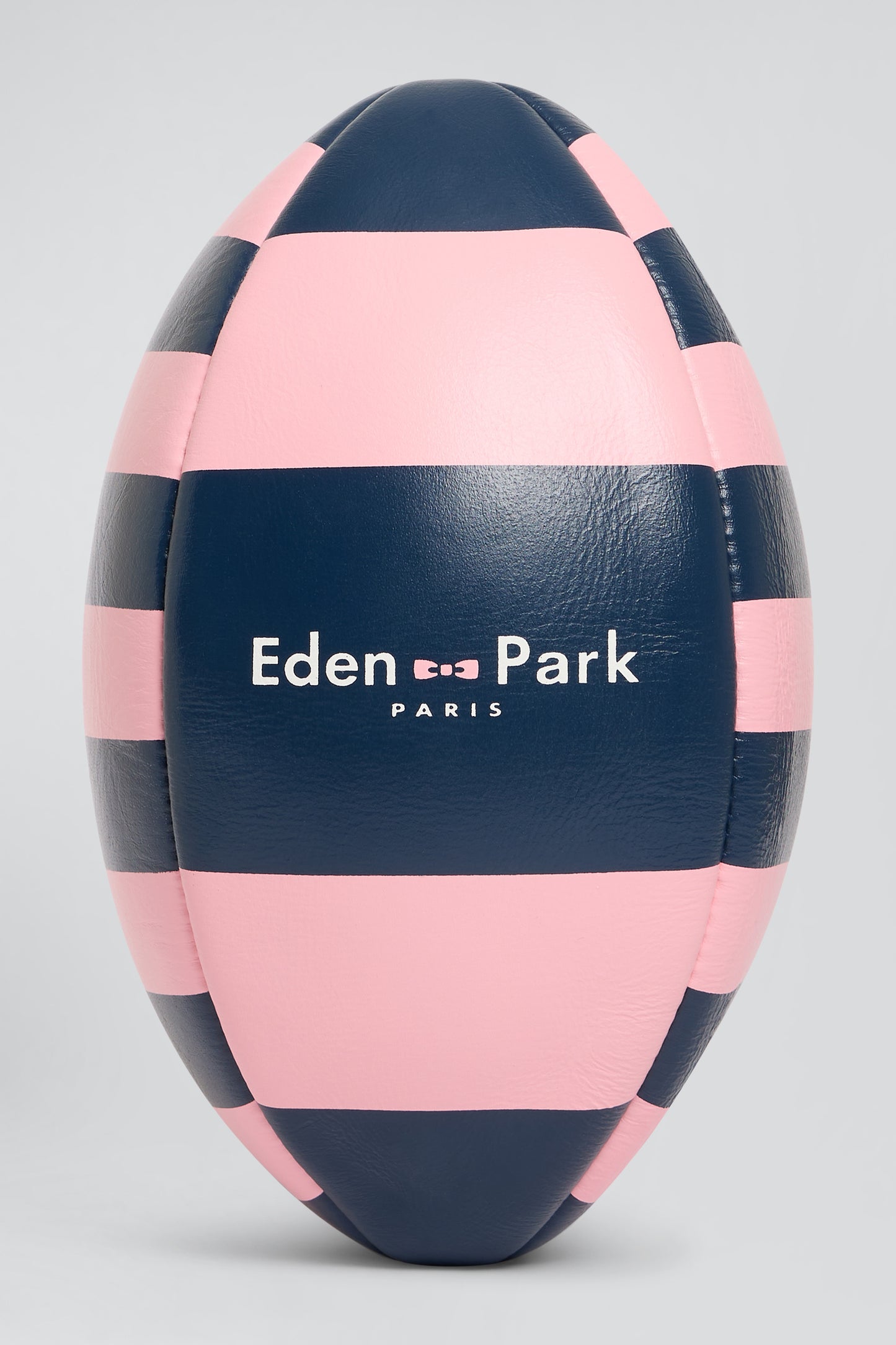 Pink leather rugby ball with striped quarters