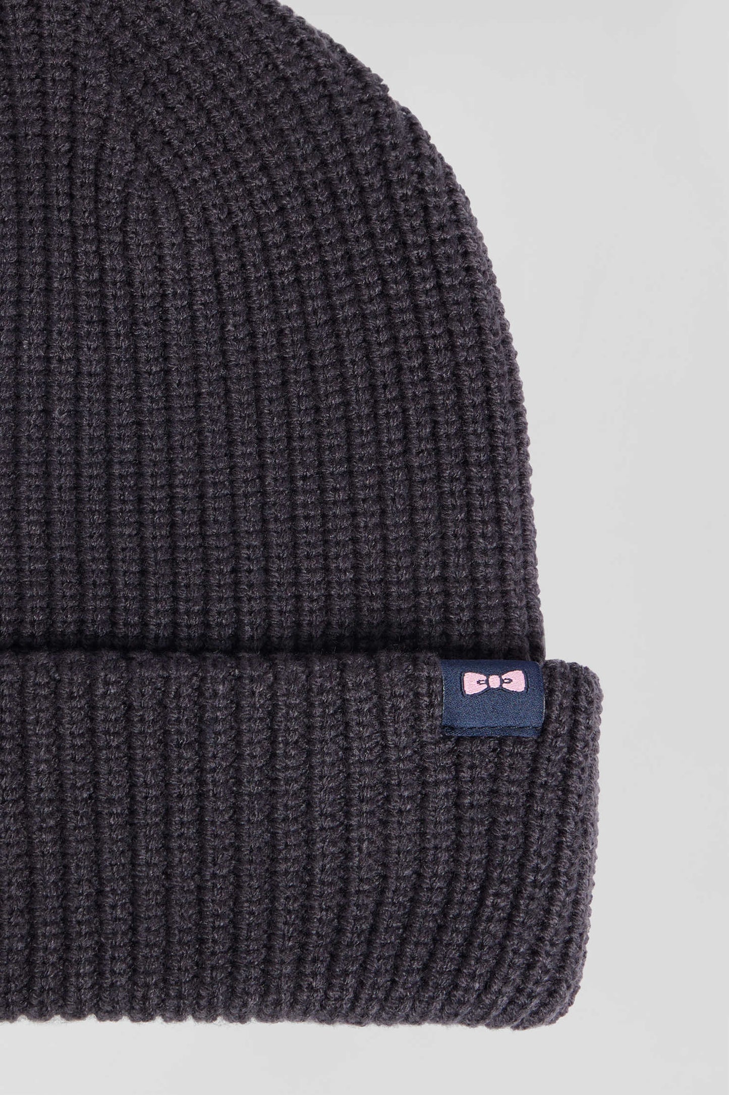 Navy blue knitted beanie with bow tie embroidery