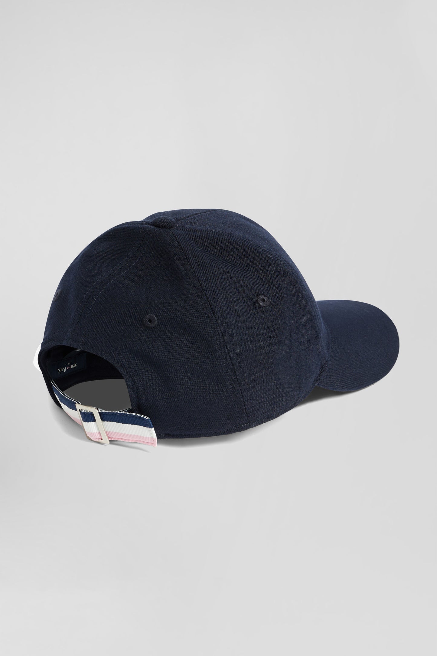 Navy blue cap with rubber badge and tricolour trim