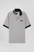 Oversize black short-sleeved cotton piqué polo shirt with tricolor details