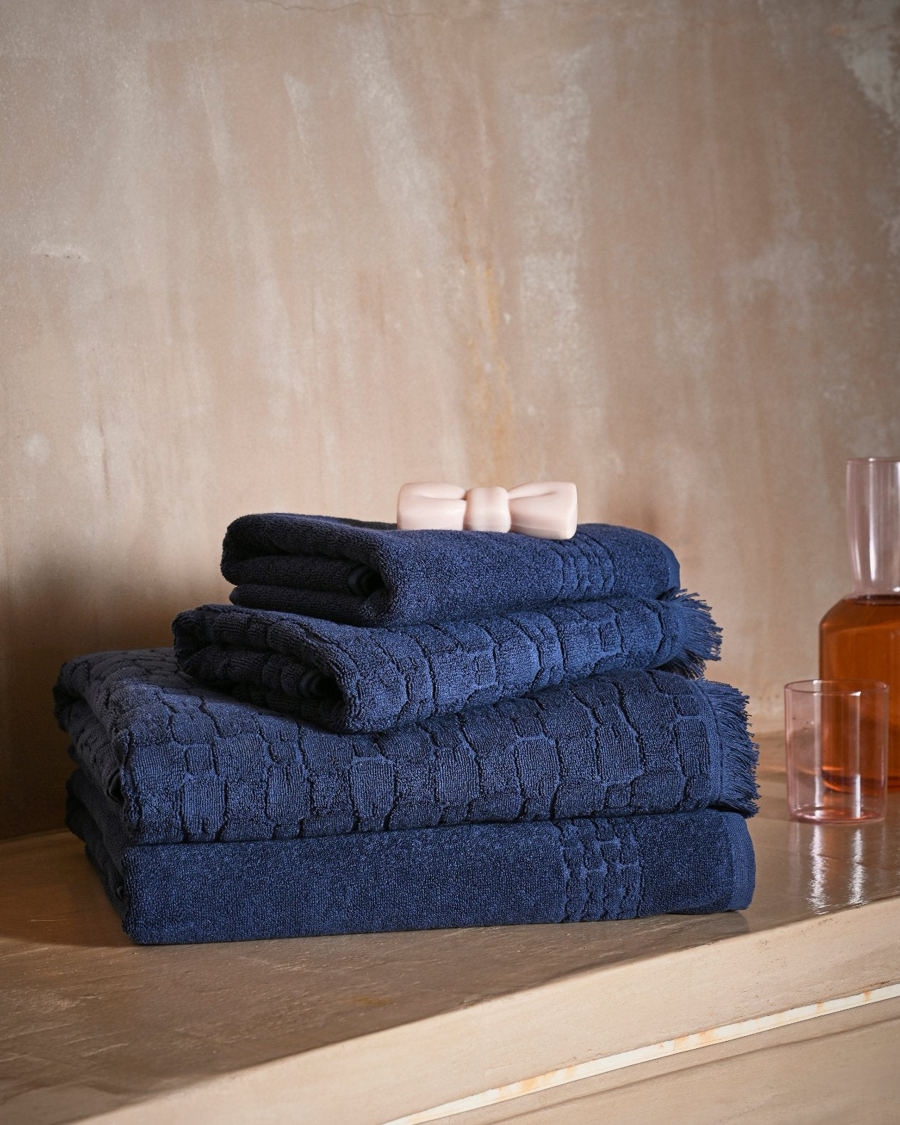 Navy cotton hand towel with bow tie micro-patterns