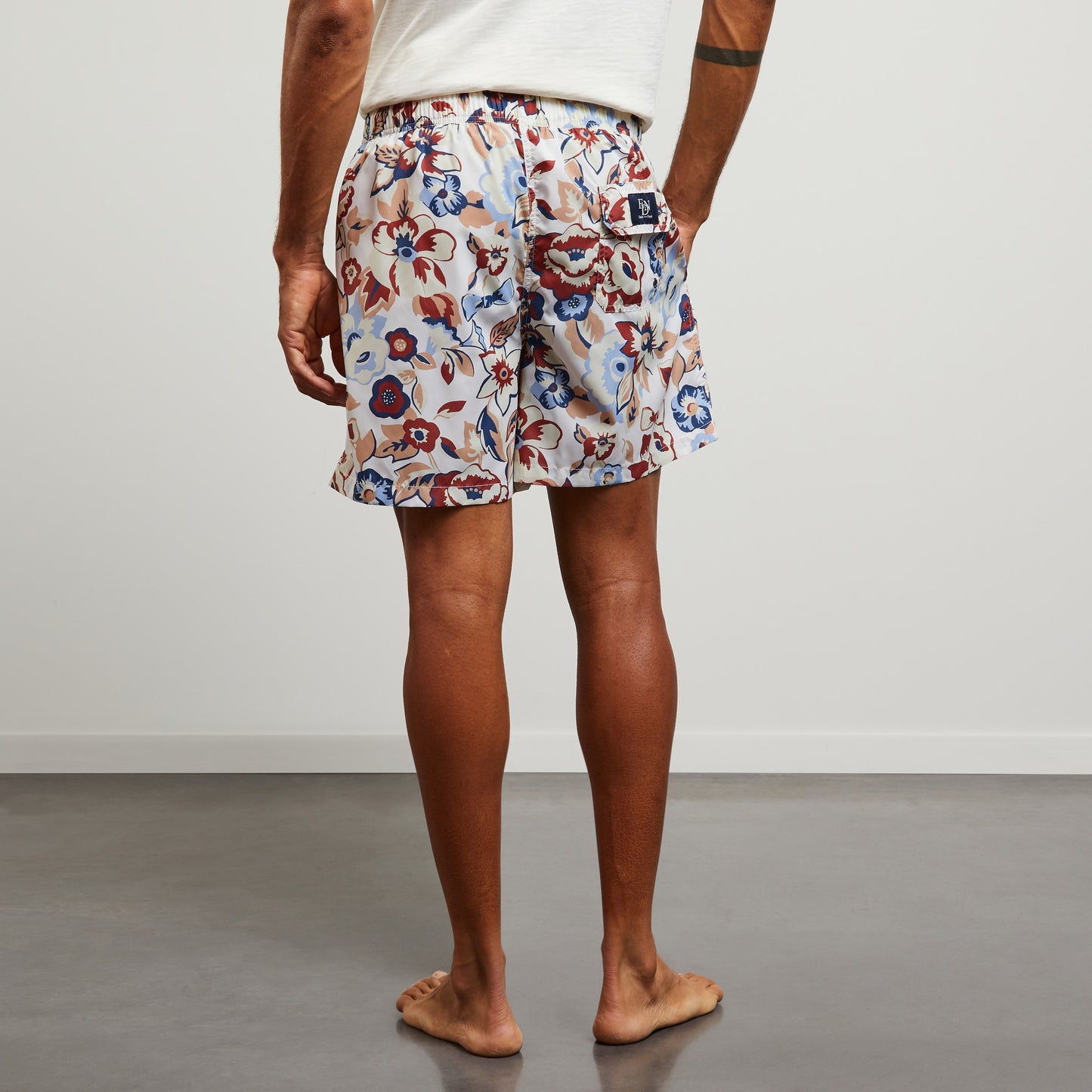 White swim shorts with exclusive floral print
