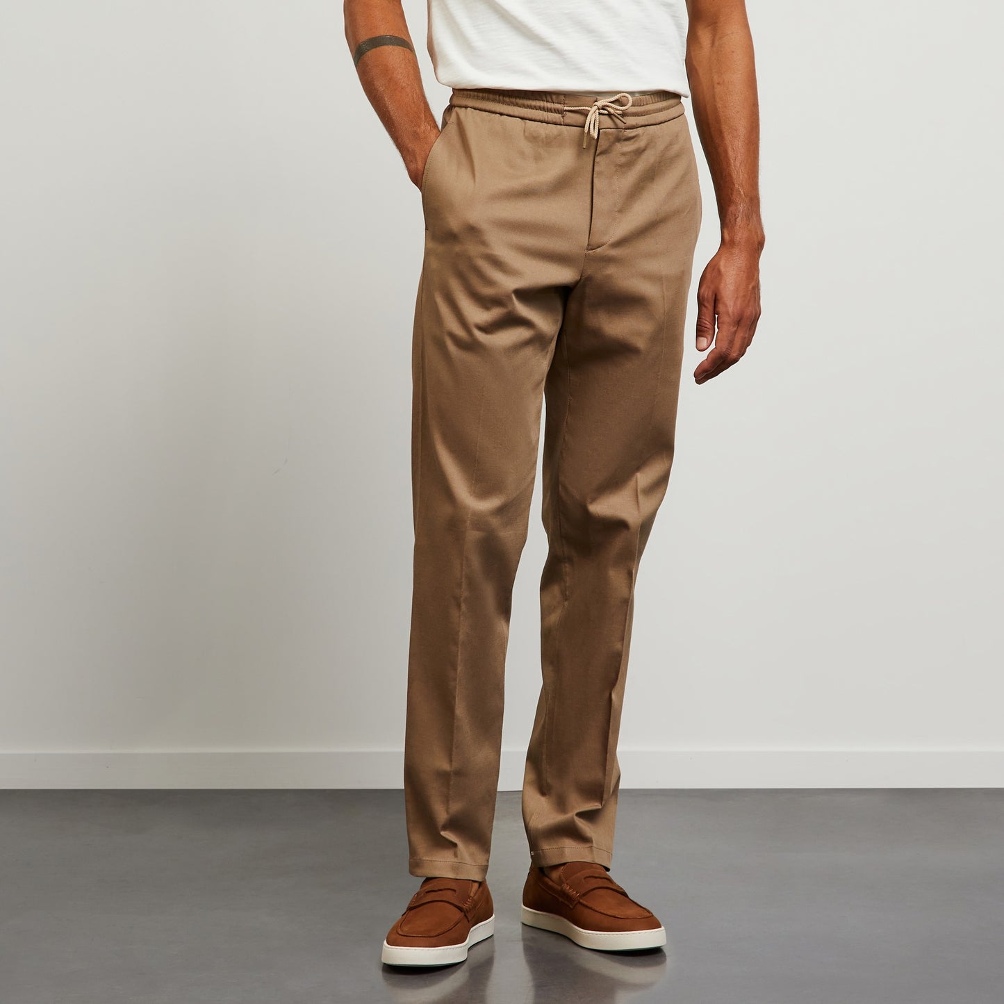 Beige trousers with loose pleats