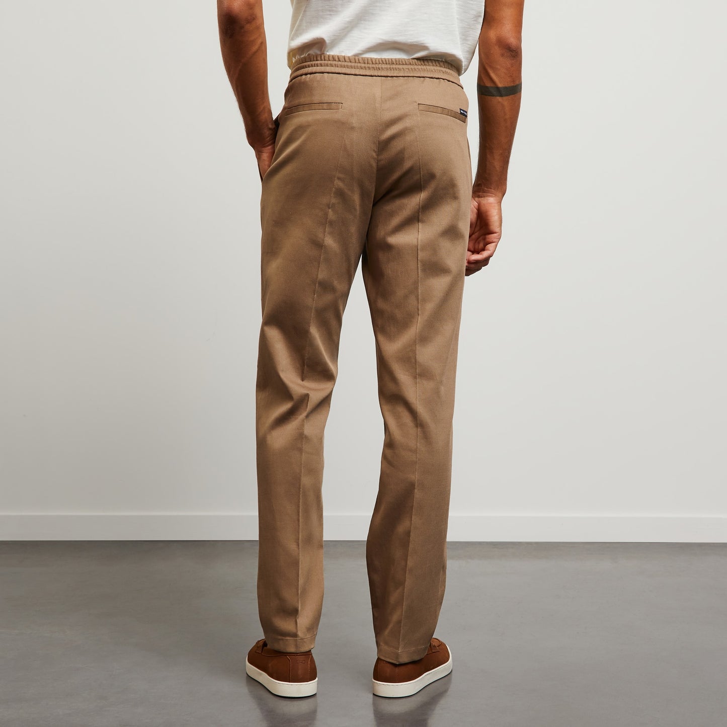 Beige trousers with loose pleats